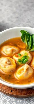 Golden fish maw soup with chicken dumplings in a bowl, garnished with green onions and served with steamed bok choy, fish maw, Chinese cuisine
