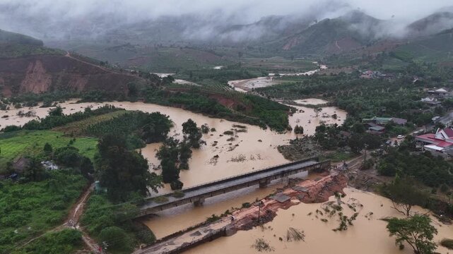 Flash Flood Devastation: Drone Flyover of Washed-Out Road, Muddy Floodwaters, and Eroded Hills