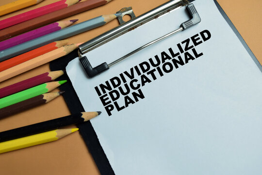 Concept of individualized educational plan write on clipboard isolated on table.