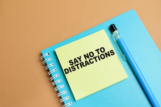 Concept of say no to distractions write on sticky notes isolated on table.