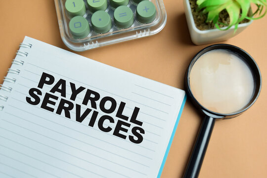 Concept of payroll services write on book isolated on table.