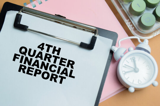 Concept of 4th quarter financial report write on clipboard isolated on table.
