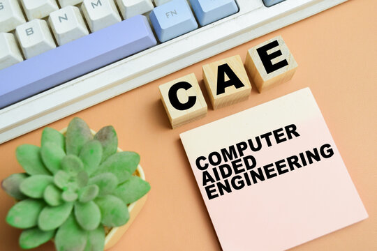 Concept of CAE - Computer Aided Engineering write on sticky notes isolated on table.