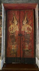 Traditional Thai Buddhist mural painting depicting Buddhist mythology on the temple wall in Bangkok, Thailand. © lawplow