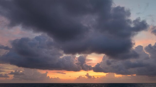 An Vertical Timelapse evocative scene of a dramatic sky, with clouds painted across a calm ocean at sunset. The clouds are ominous yet beautiful, with a striking contrast	