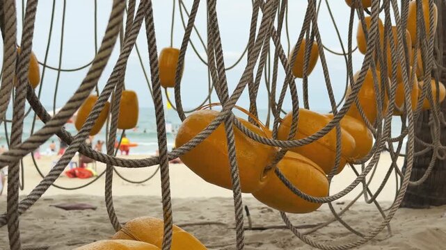 Yellow Swim Buoys on braided rope Drying on the City Beach