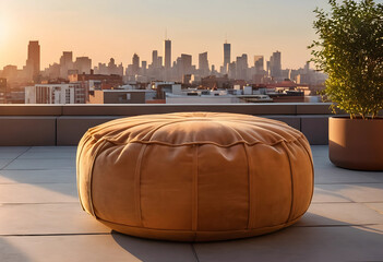 Fototapeta premium Urban rooftop living and city views, comfortable outdoor pouf on a modern terrace at sunset with skyline background
