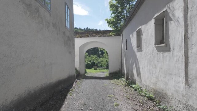 4K Video of an abounded old castle grounds walking towards a gate in Leiben, Austria
