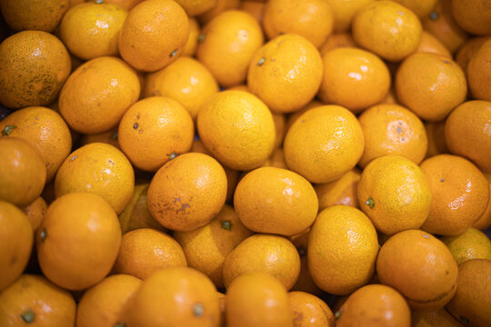 Tangerines or mandarines and slices in bamboo bowl on wooden board copy space