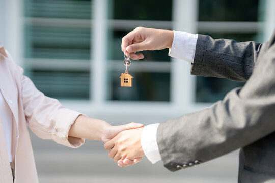 lease, rental and selling home. Real estate agent manager smile holding key for new owner. rent house, Sales, loan credit financial, insurance, Seller, dealer, installment,  buy, sell, move i