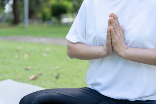 woman practicing meditate on the park. Asian woman doing exercises in morning. balance, recreation, relaxation, calm, good health, happy, relax, healthy lifestyle, reduce stress, peaceful, Attitude.