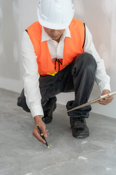 inspector or engineer is inspecting construction and quality assurance new house using a checklist. Engineers or architects or contactor work to build the house before handing it over to the homeowner
