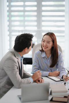 Asian office employee supervising Mentor training trainee at office