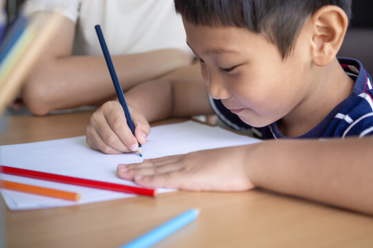 Happy Asia children playing learning paint on paper. Activity, development, IQ, EQ, meditation, brain, muscles, essential skills, family having fun spending time together. Holiday