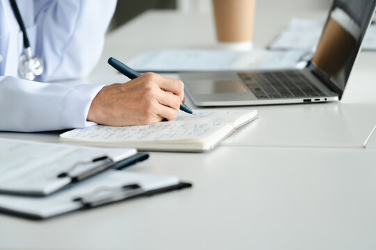 Doctor examines medical reports and patient data in clinic room