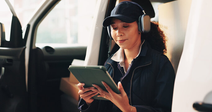 Woman, headphones and tablet by delivery van with break, reading or check courier info with music. Person, supply chain employee and relax by transport with technology, shipping details and podcast