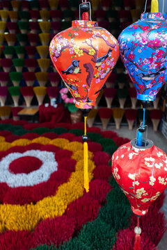 Colorful lanterns displayed in a vibrant market setting showcasing rich cultural traditions and craftsmanship in Vietnam - vertical