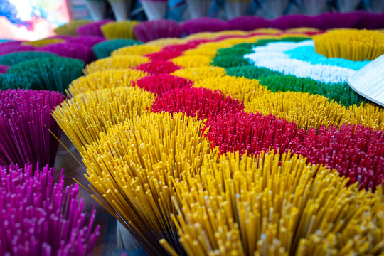 Colorful incense sticks arranged in vibrant patterns for cultural ceremonies and spiritual practices in Vietnam - horizontal
