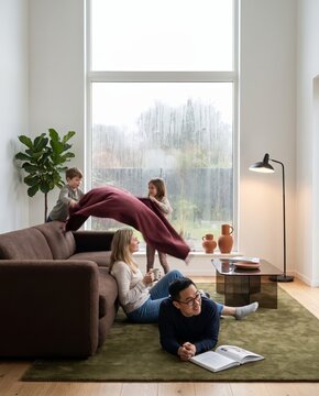 Family spending a rainy autumn day indoors with warm light in the living room