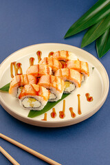 Plated seared salmon sushi rolls with sauce drizzle © Cavan