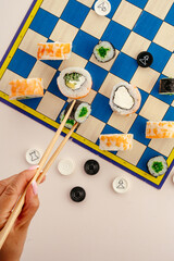 Woman playing a creative game with sushi pieces © Cavan