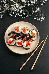 Flat lay of fresh salmon sushi with flowers © Cavan