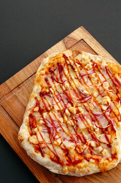Barbecue chicken flatbread pizza on a wooden board