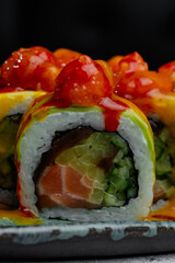 Gourmet sushi roll with salmon cucumber and spicy topping © Cavan