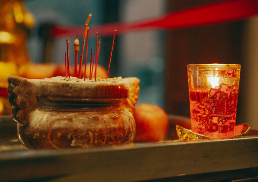 Traditional altar with burning incense and a candle
