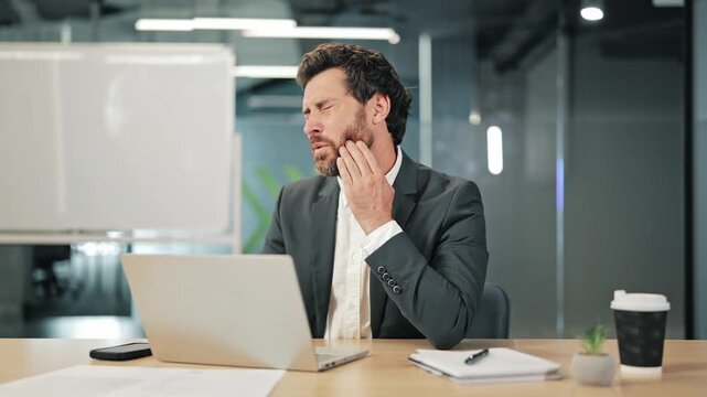 Professional experiencing sudden, severe toothache during office work. Discomfort interrupts tasks, causing distress. Needs dental relief.