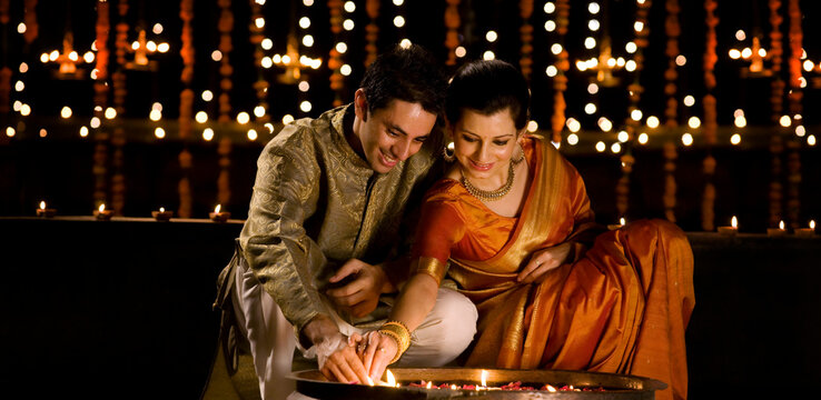 Couple lighting diyas 
