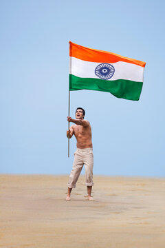 Bare chested man holding the Indian flag 