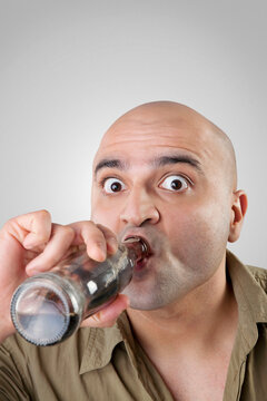 Bald man having a drink 