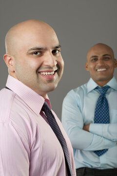 Portrait of two bald executives 