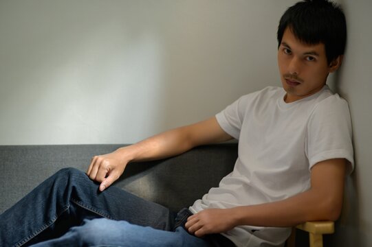 Young Man Relaxing on Couch in Casual Indoor Setting