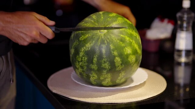 Cutting Whole Watermelon With Knife On Table 