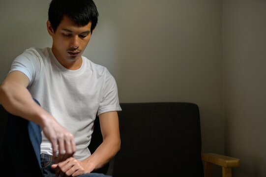 Young Man Deep in Thought in a Minimalist Indoor Setting