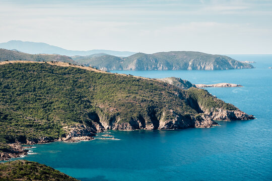 Coastal landscape with turquoise water and steep cliffs, Corsica Island