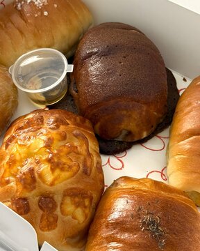 Assorted freshly baked bread in a bakery box