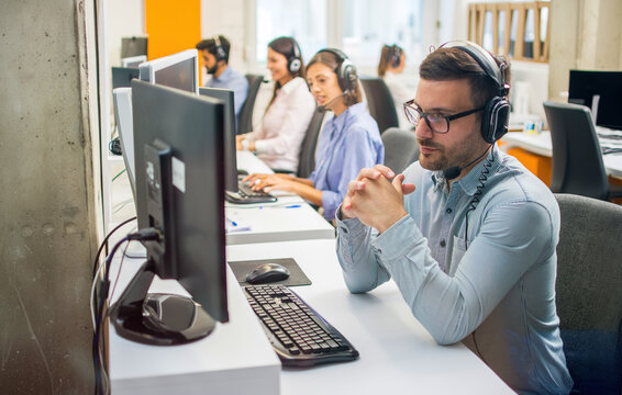 Focused businessman with headset working in support office