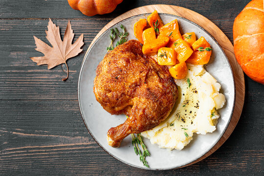 Autumn meal: chicken quarter with glazed pumpkin and mashed potato