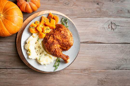 Autumn meal: chicken quarter with glazed pumpkin and mashed potato