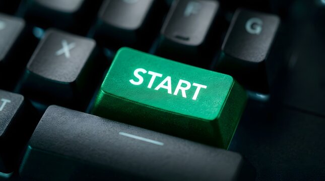 Close-up of a illuminated green start key on a mechanical keyboard with shallow depth of field.