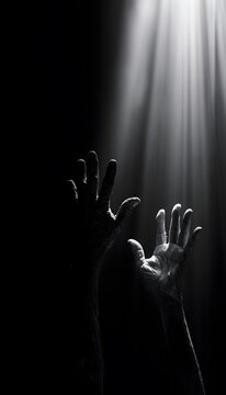 Resilient hands reach for hope a monochrome portrait of strength and enduring light beams