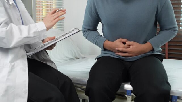 Doctor examining patient with stomach ache