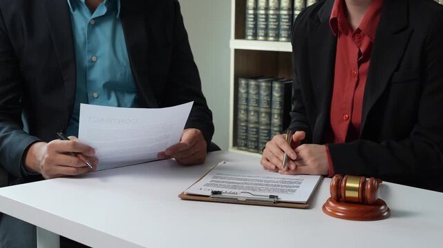 Client and lawyer discussing legal contract in law office