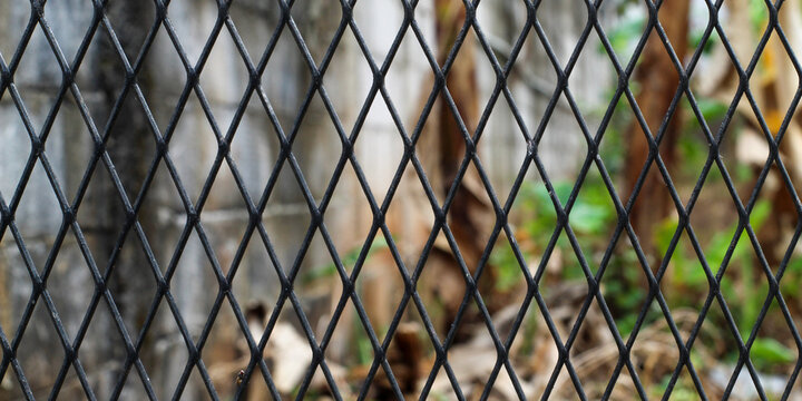Abstract Background Texture of Black Metal Wire Fence with Diamond Pattern