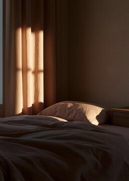 Bedroom with a bed in the foreground. the bed is covered with a dark grey comforter and a beige pillow.