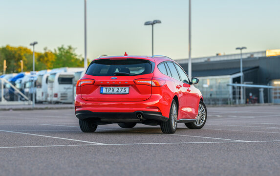 Gothenburg, Sweden - May 21 2026: Red Ford Focus estate car driving concept in open parking lot.