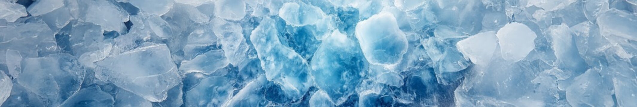 A close-up view of textured ice fragments with varying shades of blue and white, showcasing natural crystalline patterns and translucent surfaces.